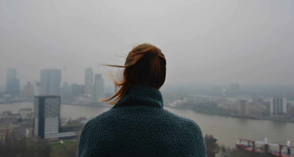 woman overlooking a city in smog